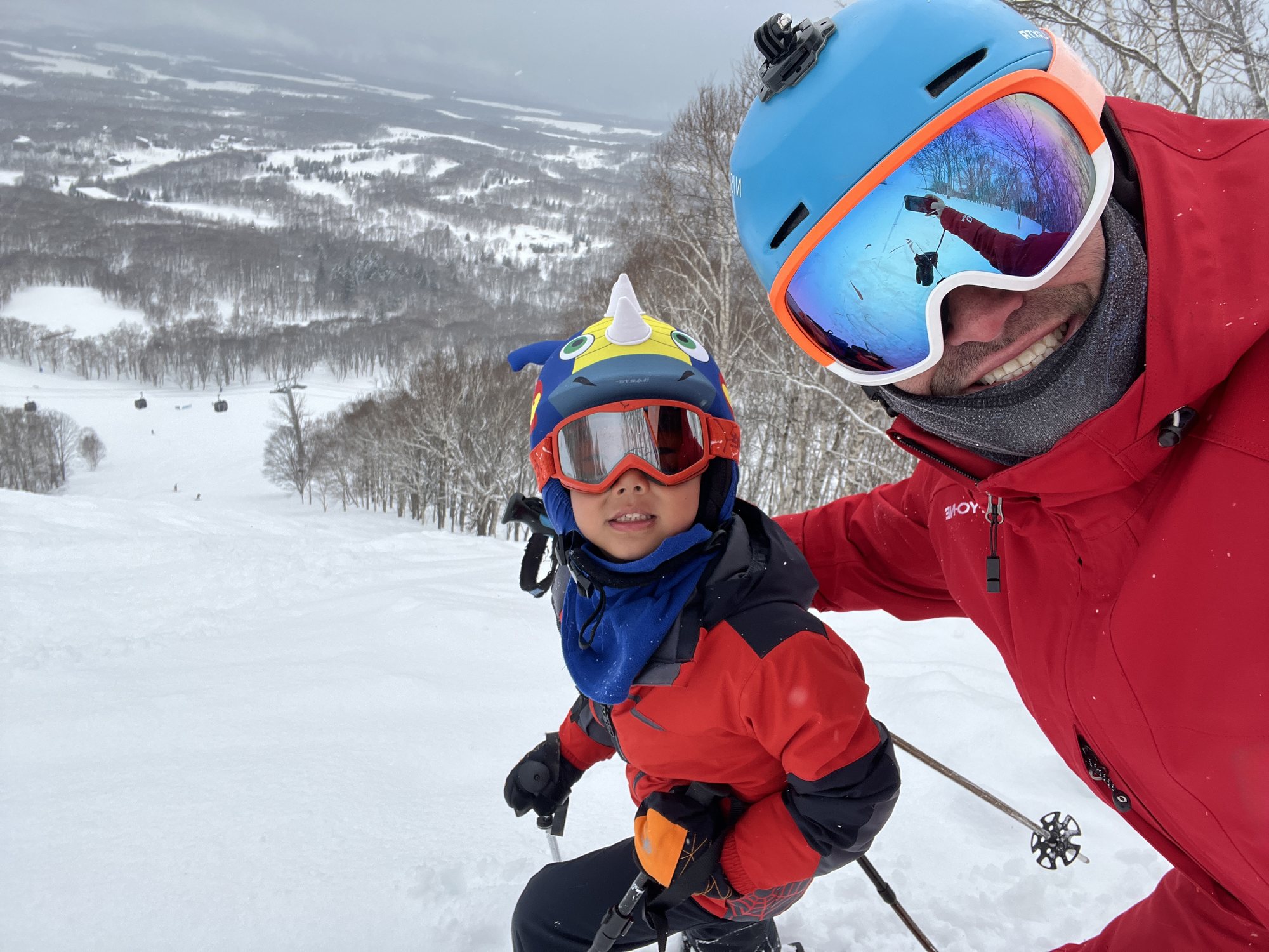 Ash Johns skiing with a young guest in Japan